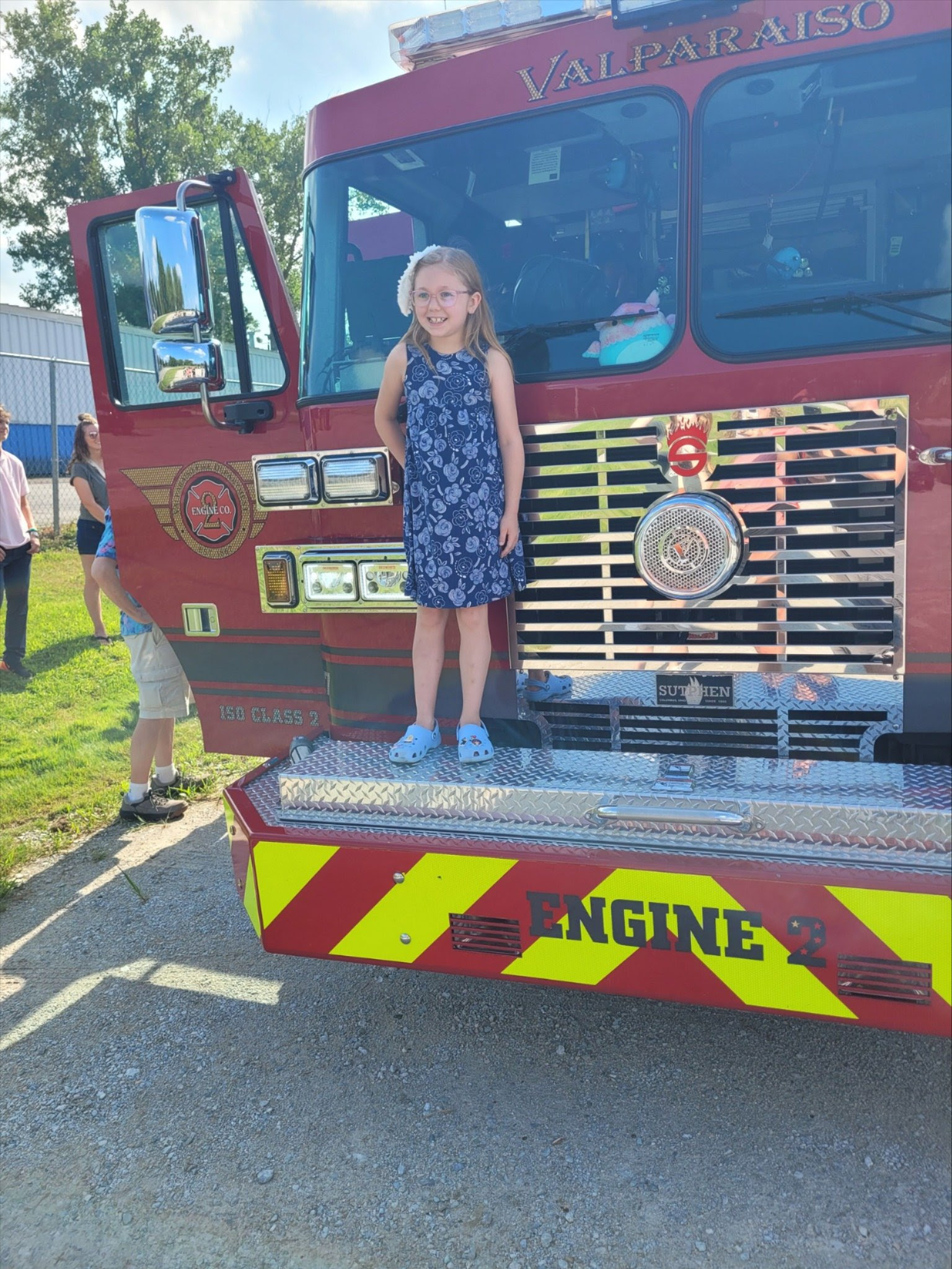 Fire Buddy standing on the from bumper of a Valparasio FD Engine.